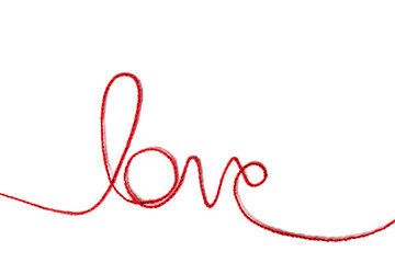 Red yarn in the shape of a word - love on white background.Red thread. Valentine's Day