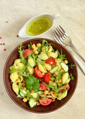Mediterranean pasta salad with vegetables and chickpeas, vertical, top view 