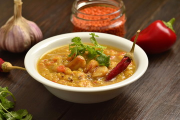 Dal, red lentil soup with turmeric, garlic, chili and cilantro. Indian food.