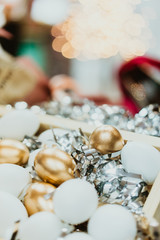 Top view of golden easter eggs colored with golden paint and white in wooden basket.Vintage film tone.Happy easter day.