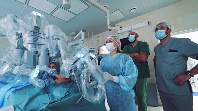 Medical robot. Robotic Surgery. Manipulators performing surgery on a man