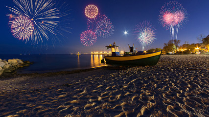 Happy New Year fireworks over Baltic Sea on the beach in Gdynia. Poland, Europe