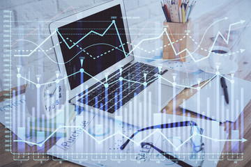 Financial graph colorful drawing and table with computer on background. Double exposure. Concept of international markets.