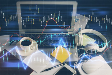Double exposure of chart and financial info and work space with computer background. Concept of...