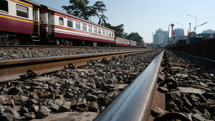 Metal tracks and The Train car with the clear blue sky at Thonburi Railway Station in Bangkok Thailand