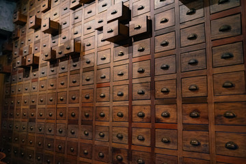 Old wooden textured drawers background in china.Herbal medicine shop in china.Vintage asian objects.
