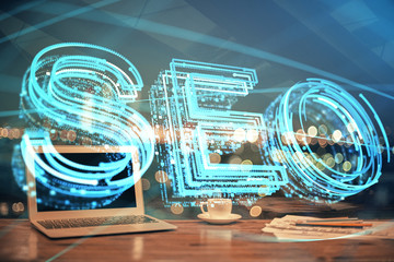 Multi exposure of table with computer and seo drawing hologram. Search optimization concept.