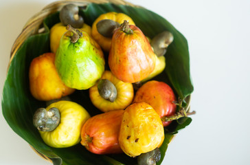 Fresh Cashew nuts on banana leaf.Raw cashews in wooden bowl.