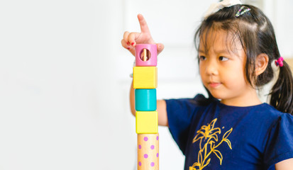 5 years old girl.Little child girl playing with lots of wooden toys block with mother.Kids play with educational toys at home.Day care and Kindergarten school.child development concept.