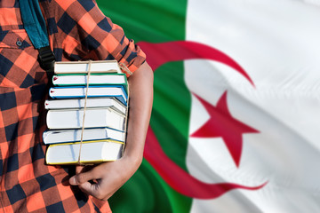 Algeria national education concept. Close up of teenage student holding books under his arm with...