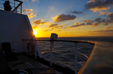 Vacation and traveling on luxury cruise ship liner with beautiful panoramic sunrise or sunset over...