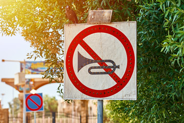 No horn sign in the city street. No honk and no noise for car