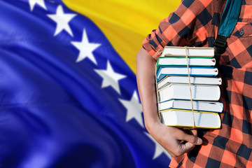 Bosnia Herzegovina national education concept. Close up of teenage student holding books under his...