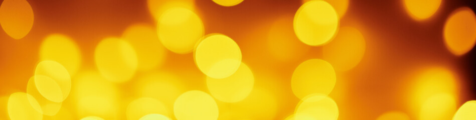 Background of golden lights in a bokeh. Defocused abstract blurred lights