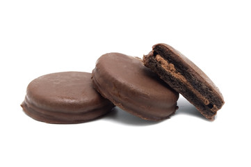 Chocolate sandwich cookies filled and coated with chocolate cream isolated on white background.