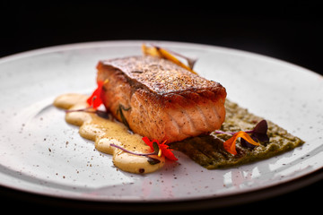Grilled trout. Trout steak on a white plate