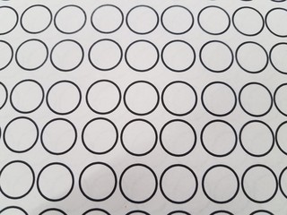 small black circles on white paper or background