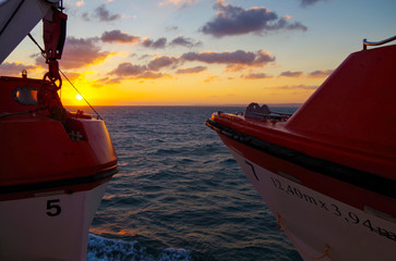 Vacation and traveling on luxury cruise ship liner with beautiful panoramic sunrise or sunset over...