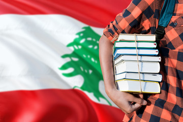 Lebanon national education concept. Close up of teenage student holding books under his arm with...