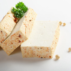 Soy Bean curd tofu with greens on white background Non-dairy alternative substitute for cheese