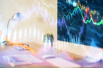 Stock market graph on background with desk and personal computer. Double exposure. Concept of financial analysis.