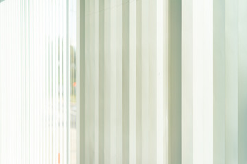 Close up Vertical window blinds in Office .Interior with light shining through in white window blinds.