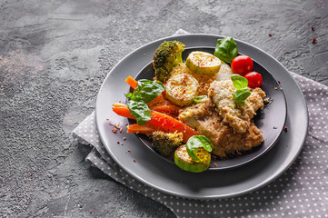 Close-up cod with baked vegetables and fresh basil. Healthy and tasty food. Traditional cuisine seafood.