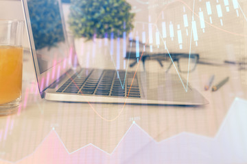 Forex graph hologram on table with computer background. Multi exposure. Concept of financial markets.