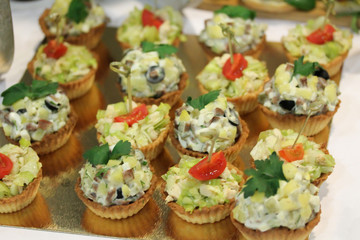 Salad muffins snacks at the stand-up party or buffet lunch. Tasty food treats on the table. Catering service.