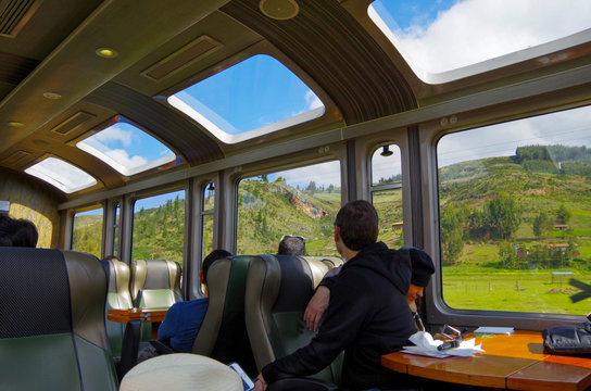 Traveling on train to Machu Picchu starting point Aguascalientes through the panoramic landscape of Peru onboard panorama window view carriage of Perurail