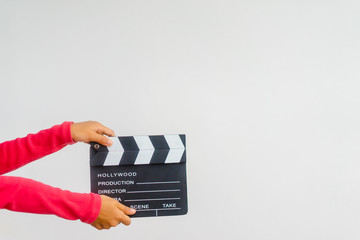 Kid hands holding clapper board for making video cinema in studio.Movie production clapper board or...