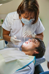 Obraz na płótnie Canvas Young man at the dentist