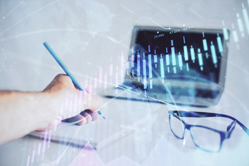 Multi exposure of man hands with stock market forex graph.