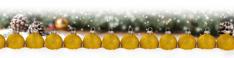 Group of Red Christmas Balls in a Row on Spruce Branch Background