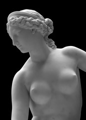 White marble sculpture head of young woman. Statue of sensual renaissance art era naked woman in...