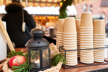 Mulled wine in Christmas market. Paper cups for Christmas mulled wine in old town Small European City.