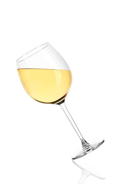 Full glass of white wine isolated on white background. The glass is tilted in.