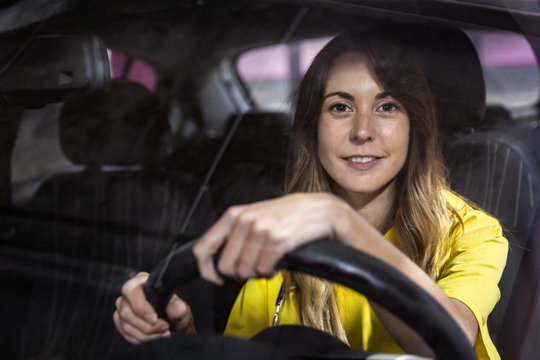 Attractive Young Girl Riding In Her Car To Go To Work At The Hospital As A Nurse.