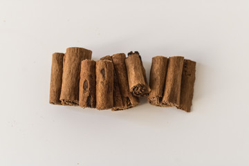 Cinnamon sticks (Cinnamomum) closeup on white background top view, cinnamon rolls close-up - Image