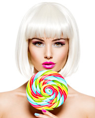 Face of a beautiful  girl with bob hairstyle  and multicolor sweet candy.