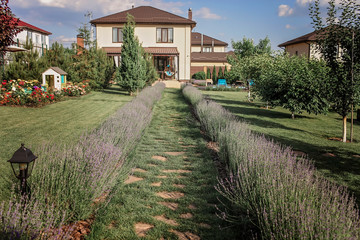Green garden outside of modern vacation house, creation a home and home feeling