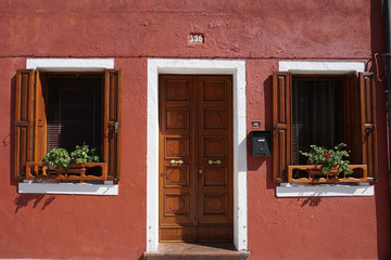 Fototapeta na wymiar Windows and door, brown fasade