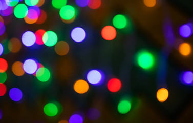 Festive background - multicolored blurry lights. The concept of celebration, new year, event, party. Copyspace. Red, green, purple shades.