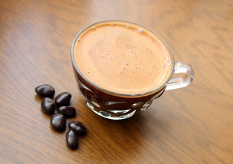 cup of coffee on a wooden background