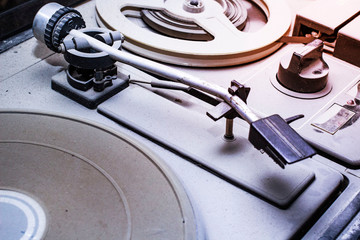 an old reel-to-reel tape recorder and gramophone in a thick layer of dust, the front and back...