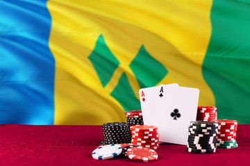 Saint Vincent And The Grenadines casino theme. Aces in poker game, cards and chips on red table...