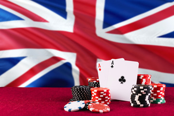 United Kingdom casino theme. Aces in poker game, cards and chips on red table with national flag...
