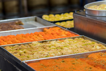 Kanafeh (traditional Middle Eastern dessert. Delicious arabic pastry) Milky and delicious made of noodle-like pastry. Baked with goat cheese, and sugar syrup. Mahane Yehuda Market, Jerusalem, Israel.