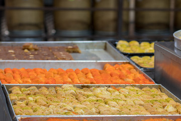 Kanafeh (traditional Middle Eastern dessert. Delicious arabic pastry) Milky and delicious made of noodle-like pastry. Baked with goat cheese, and sugar syrup. Mahane Yehuda Market, Jerusalem, Israel.