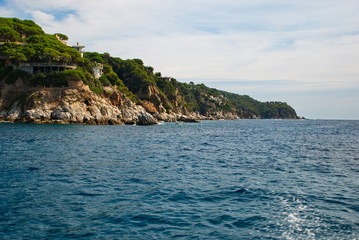 Fototapeta premium Barcelona, Spain - 18.08.2019: Rocky spanish coast and blue sea in spain